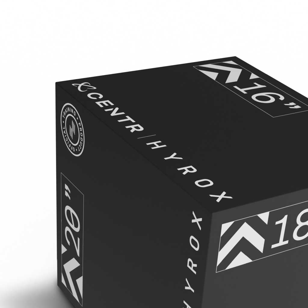 Close-up of the white CENTR and HYROX logos and size markings on a black foam plyometric box.