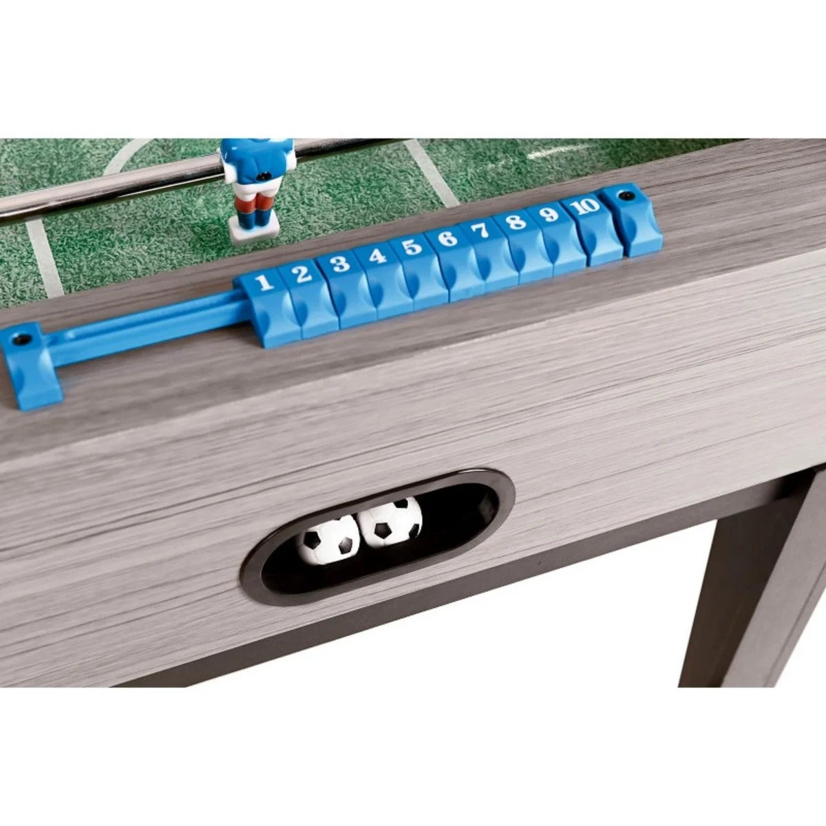 Close-up of a blue score counter and black round rod bearing on the grey side panel of the football table.