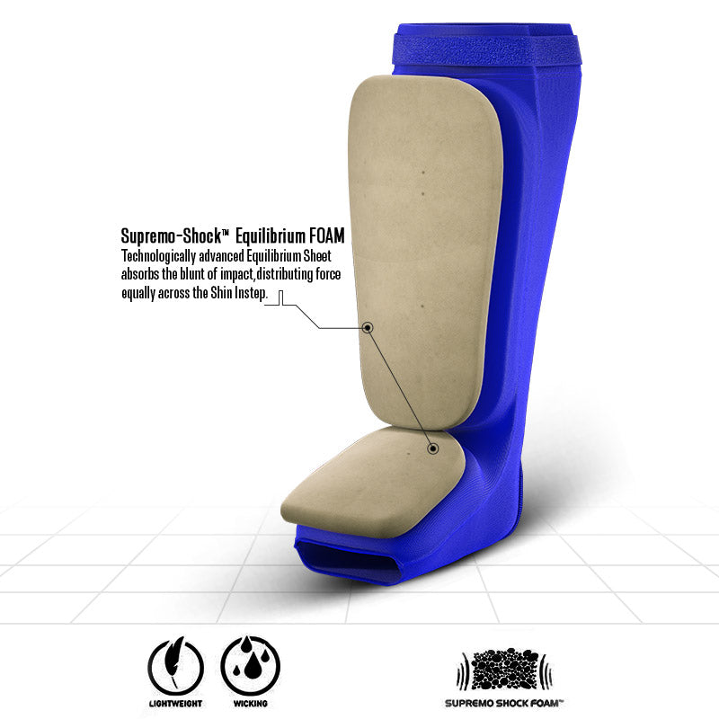 Blue shin and instep guard with a beige inner surface and an inset showing the layered padding.