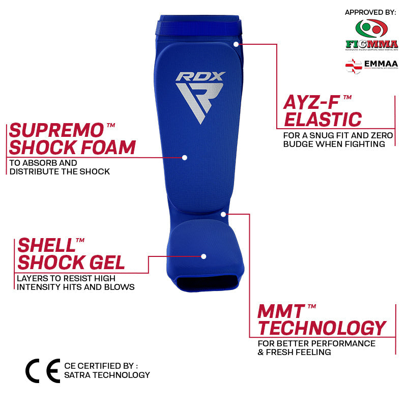 Blue shin guard with an RDX logo and labels reading “SUPREMO+ SHOCK FOAM,” “SHELL SHOCK GEL,” and “MMT TECHNOLOGY.”
