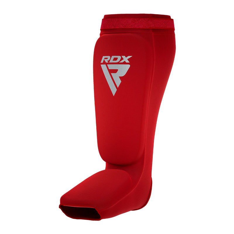 Red shin and instep guard with a white RDX logo, viewed from the front against a white background.