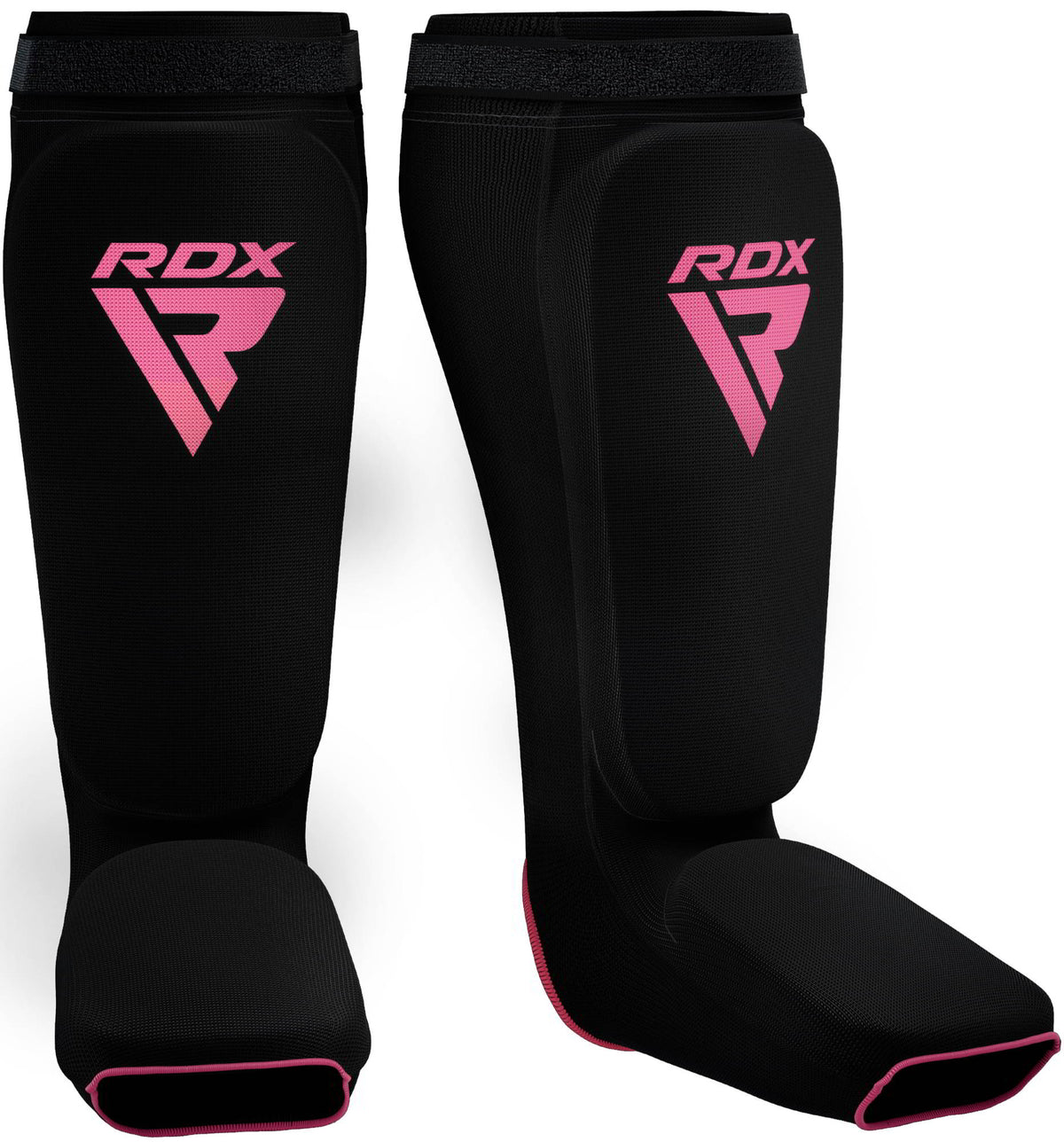 A pair of black shin and instep guards with pink RDX logos and pink trim against a dark background.
