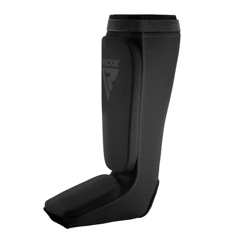 Black shin and instep guard in side view against a white background.