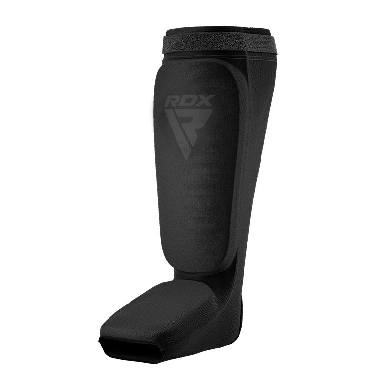 Black shin and instep guard at an angled front view against a white background.