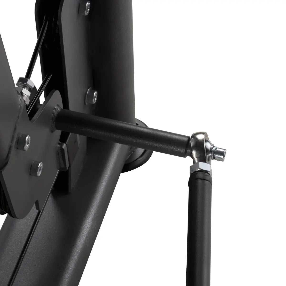 Close-up van een metalen draaipunt en bevestigingsbout op de arm van een zwarte trainingsmachine.